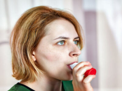 woman using powder dry inhaler
