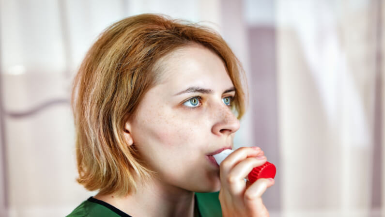 woman using powder dry inhaler